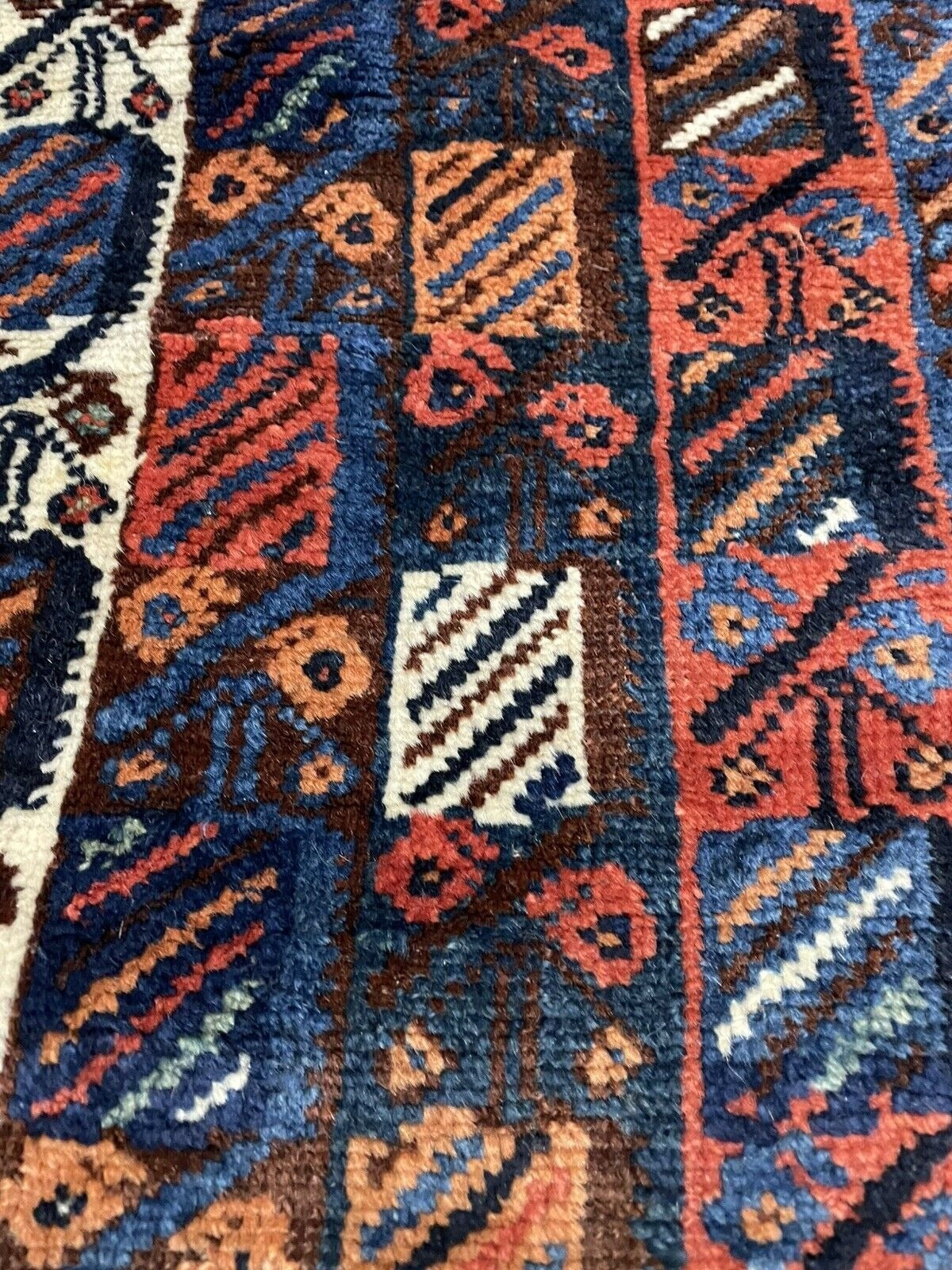 View of the rug's edge and original fringe, demonstrating its antique age.