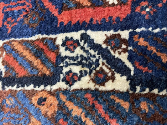 Close-up detail of a single stylized square "tile" motif in the rug's field.