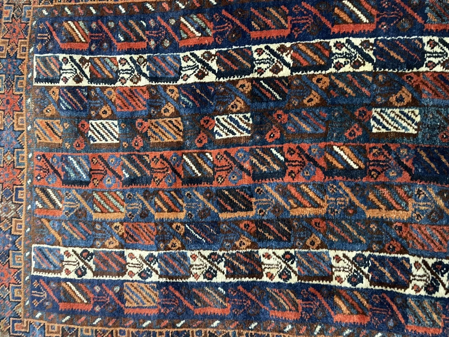 Detail highlighting the contrast between the deep red field and navy blue motifs.