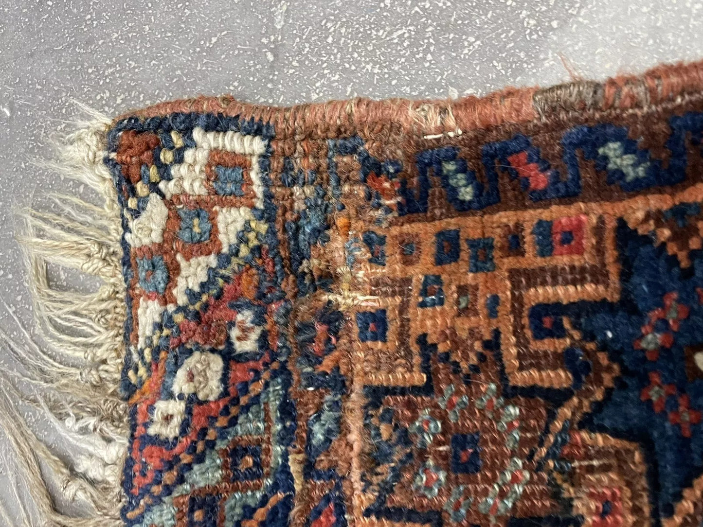 Close-up on the intricate knotting and weaving details of the tribal pattern.