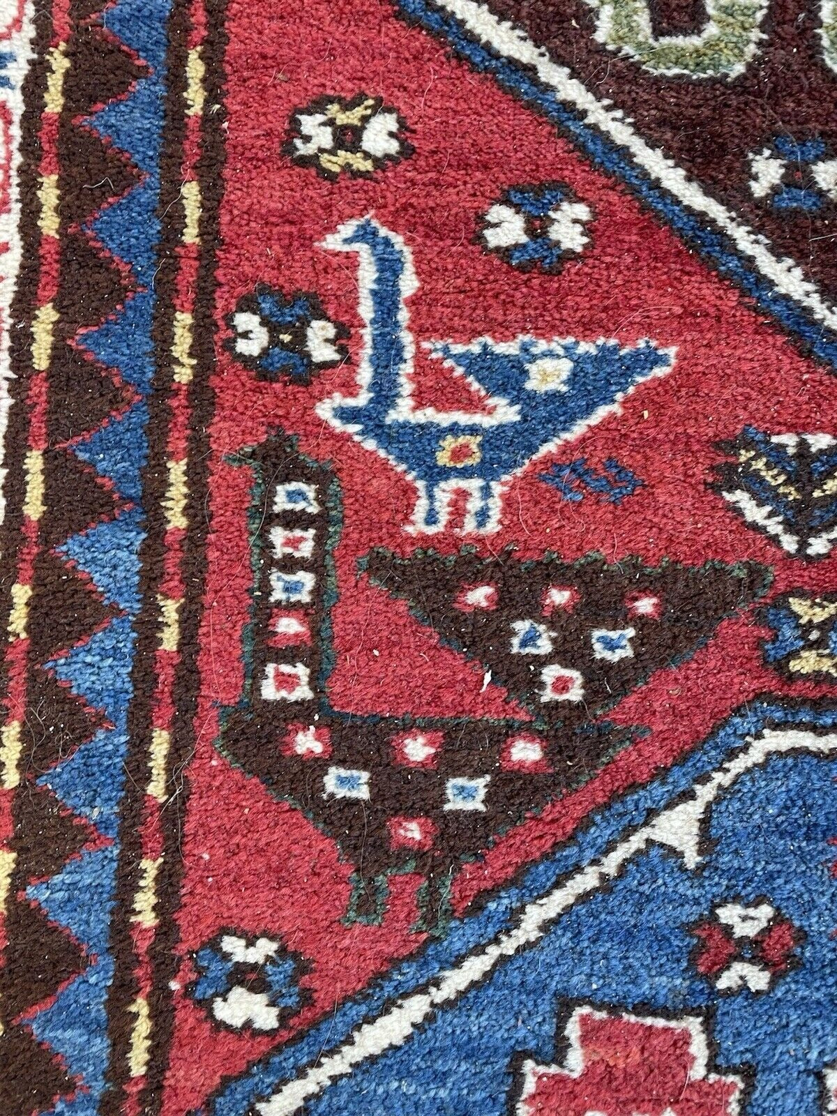 View of the rug's end, highlighting the border and field interaction.
