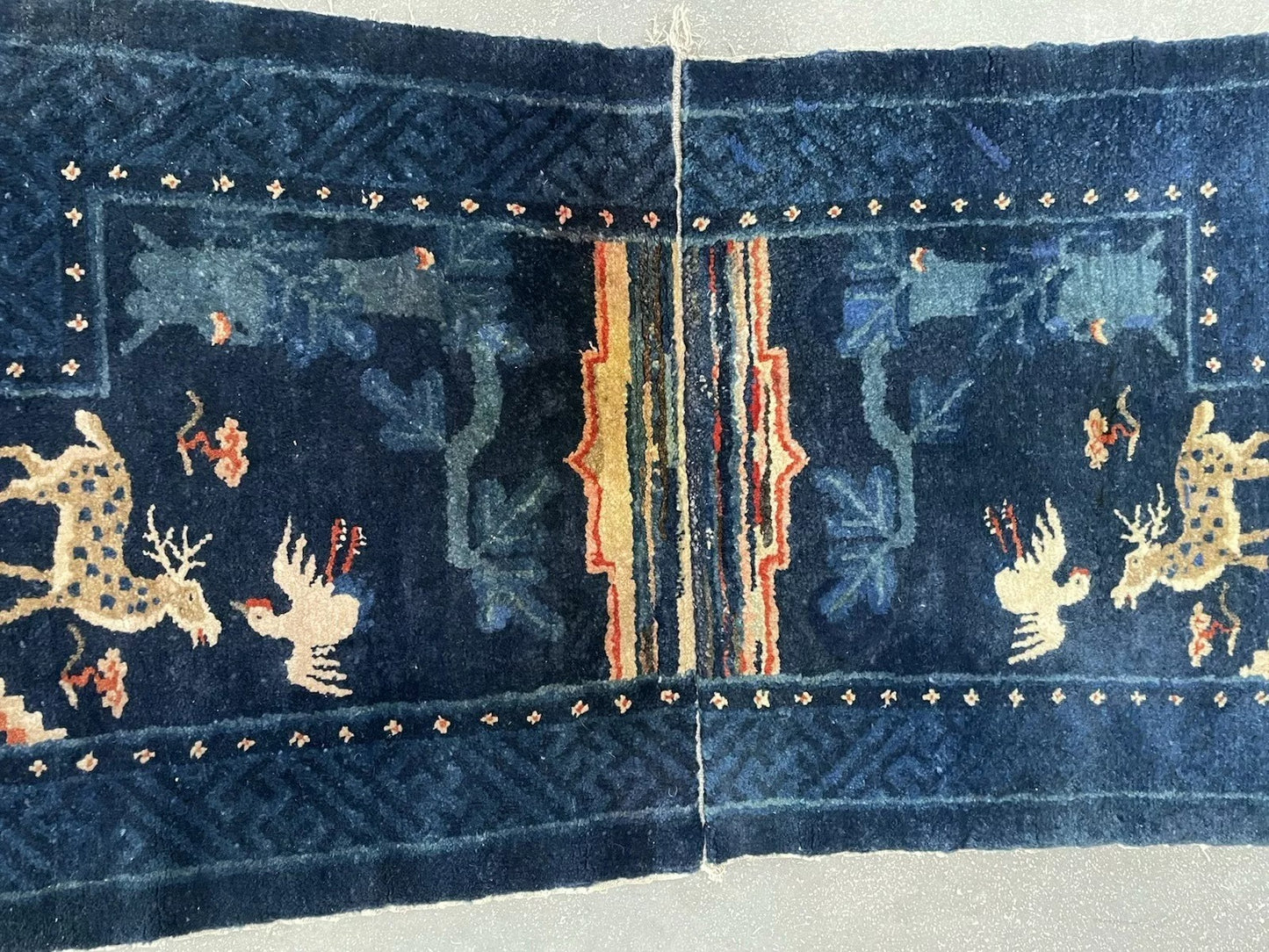 View of the rug's secondary border with its repeating geometric dots.