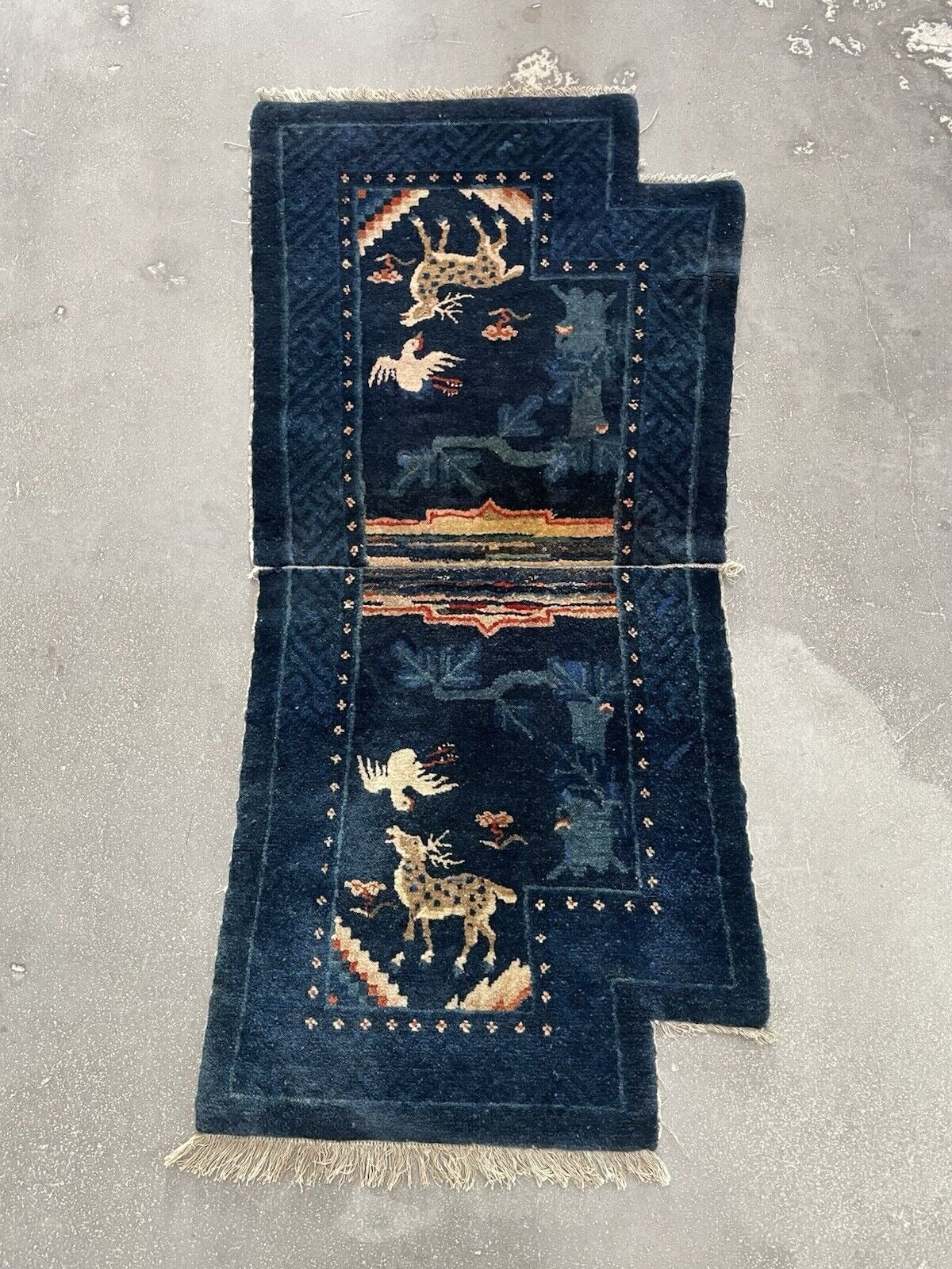 Angle shot capturing the rich, deep blue color of the rug's field.