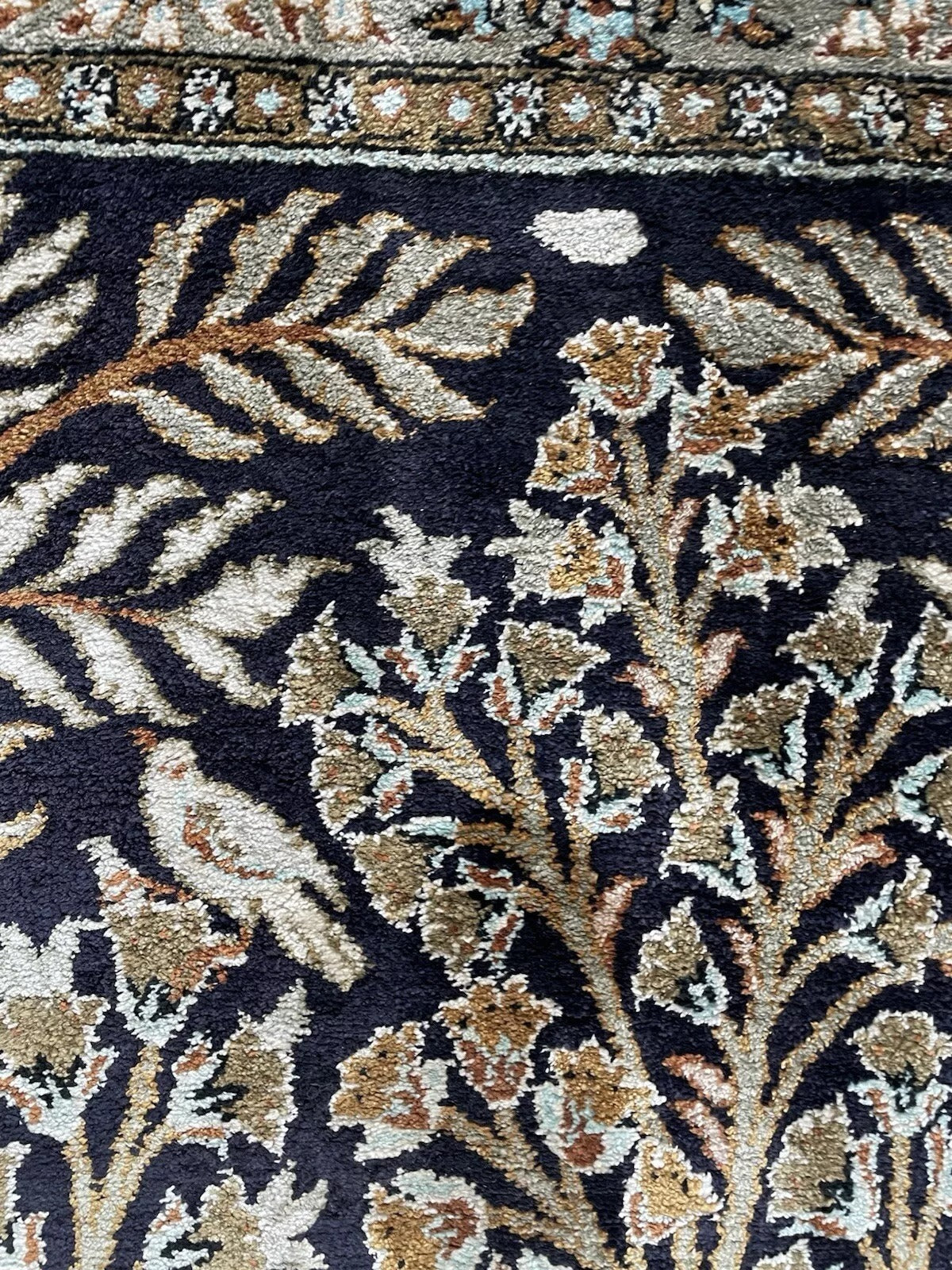 Texture shot highlighting the luminous sheen and fine knotting of the silk.