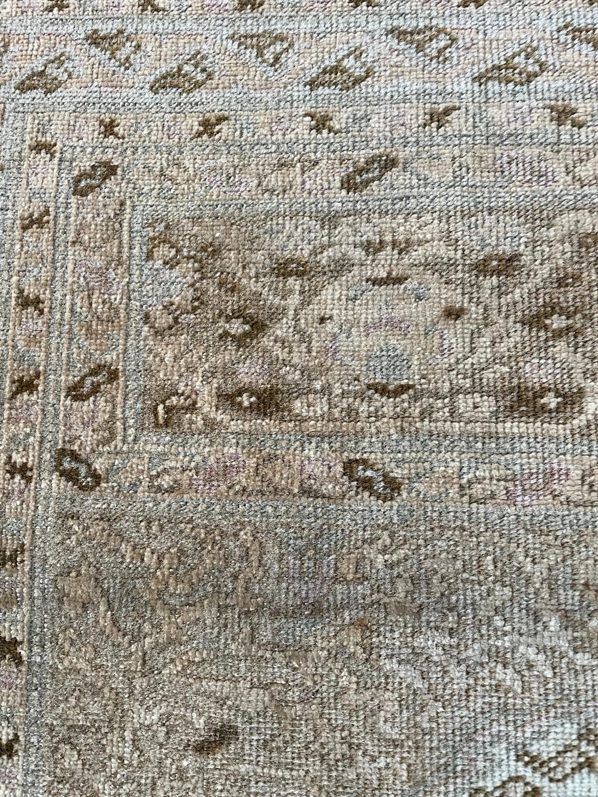 Detail of the subtle blue and brown motifs within the prayer niche.