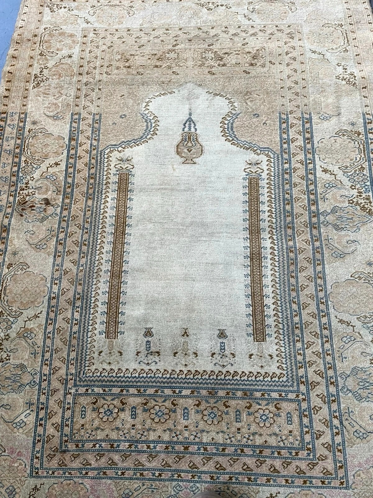 Close-up on the gentle patina and minor wear that attest to the rug's age.