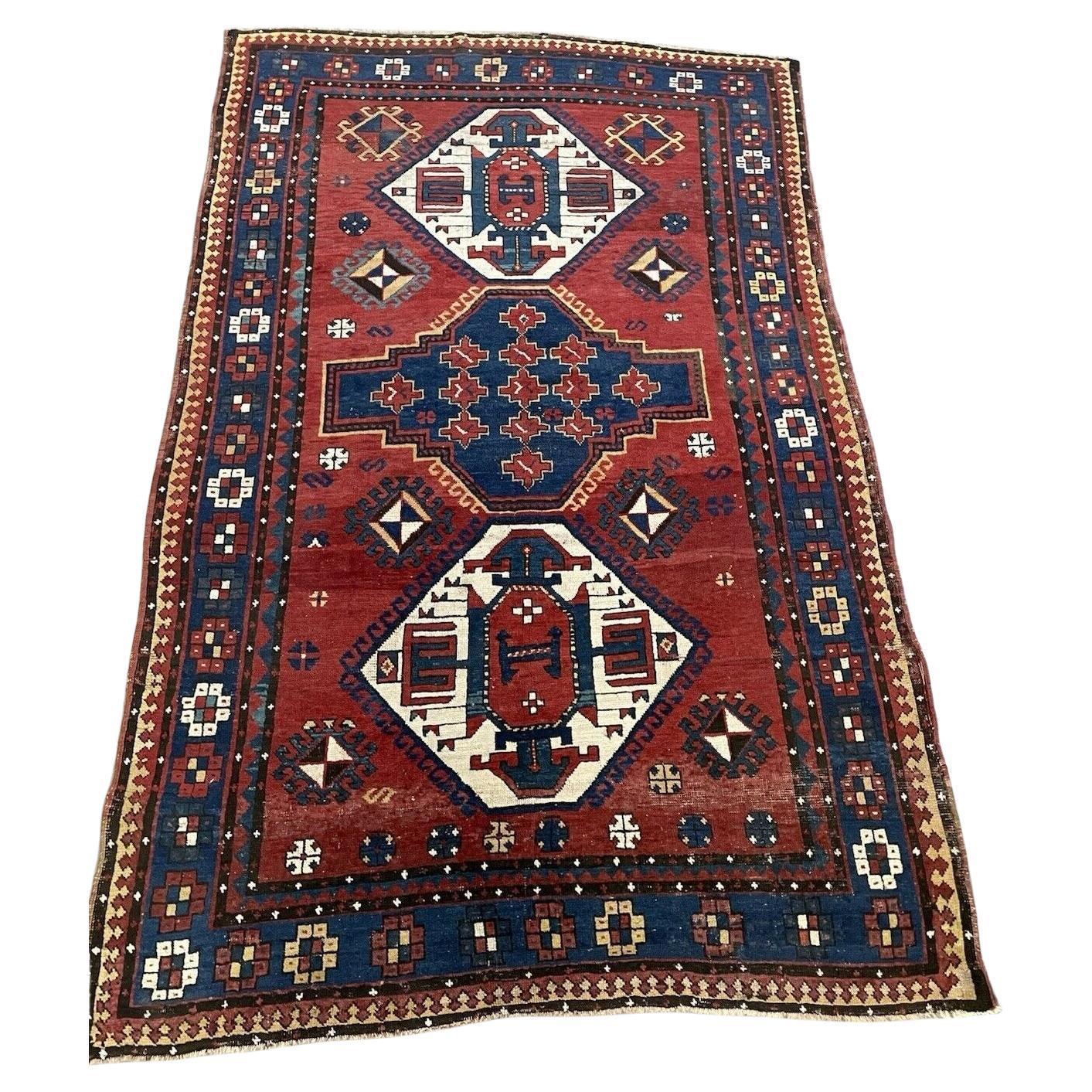 Full top view of the antique Caucasian Lori Pambak rug showing the central and flanking medallions.