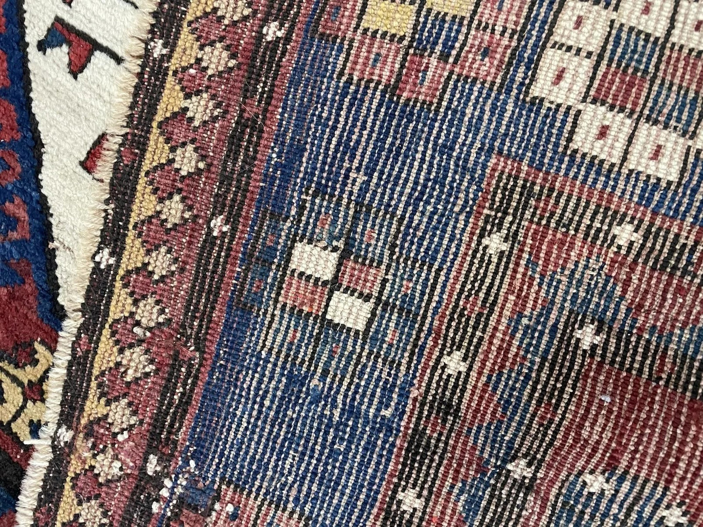 Close-up on the beautiful patina and minor age-related wear on the wool.