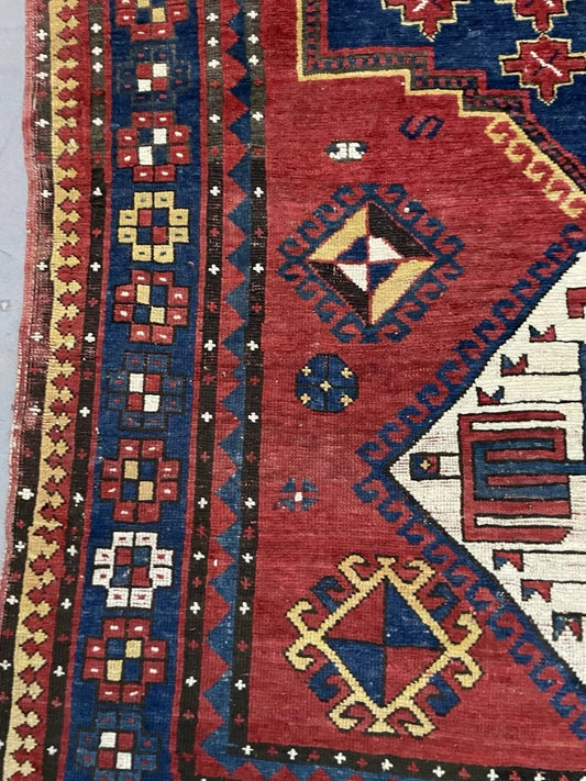 Close-up detail of the large central geometric medallion on the red field.