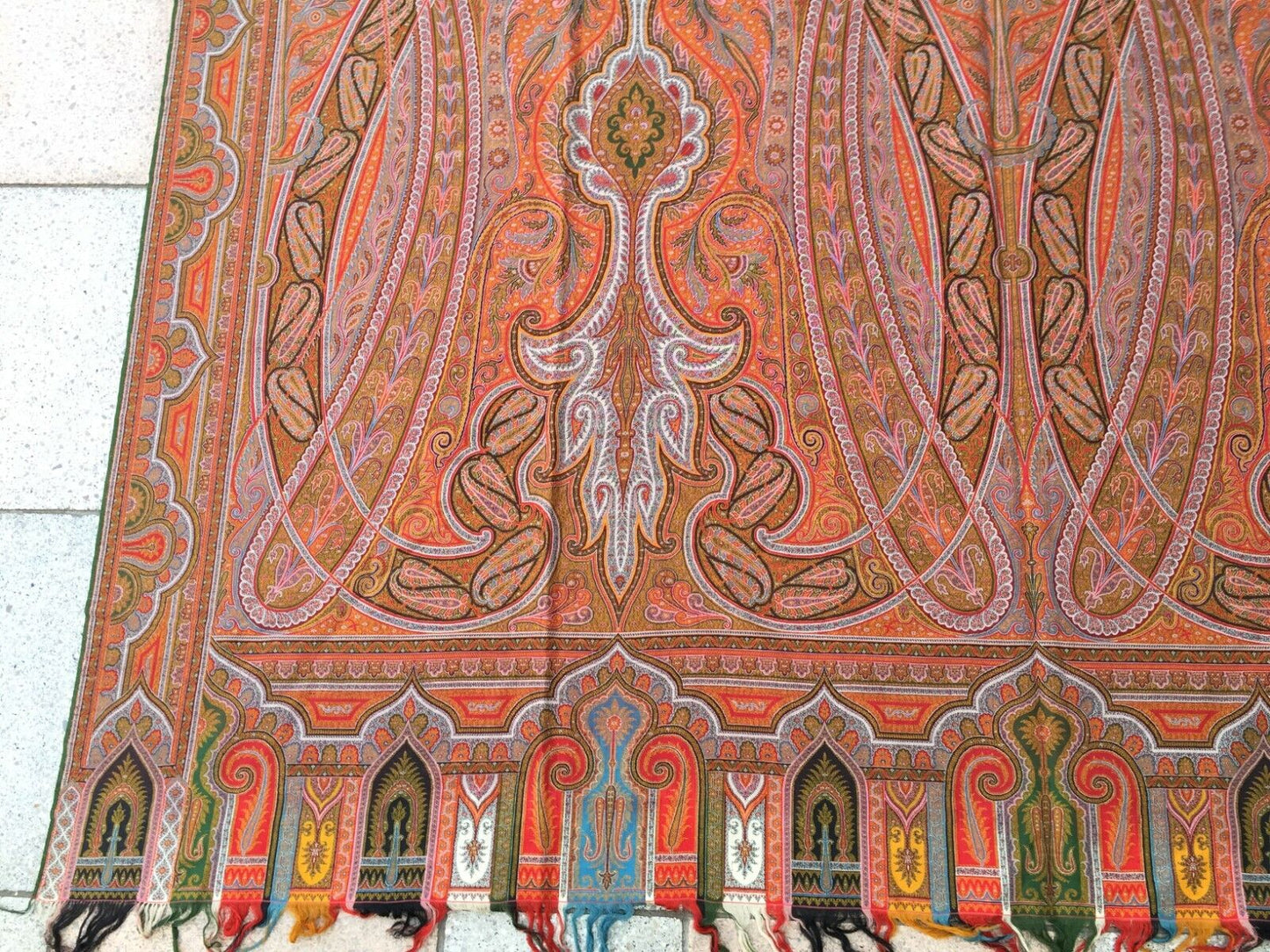 Close-up of the intricate woven patterns and symphony of shapes and symbols on the shawl