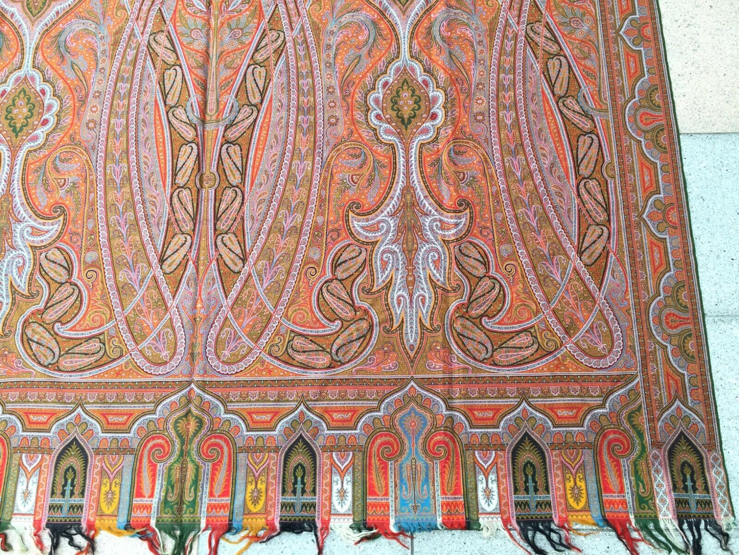 Side view of the shawl displaying its generous dimensions and vibrant colors