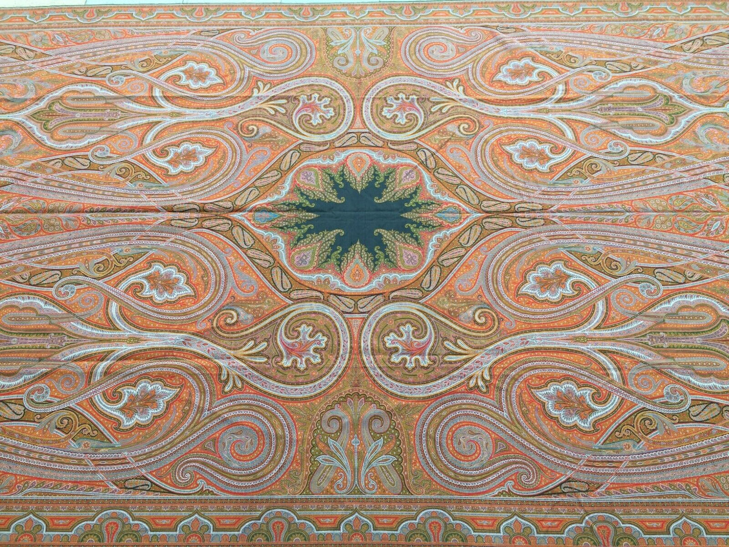 Close-up of the elaborate border designs surrounding the central motif