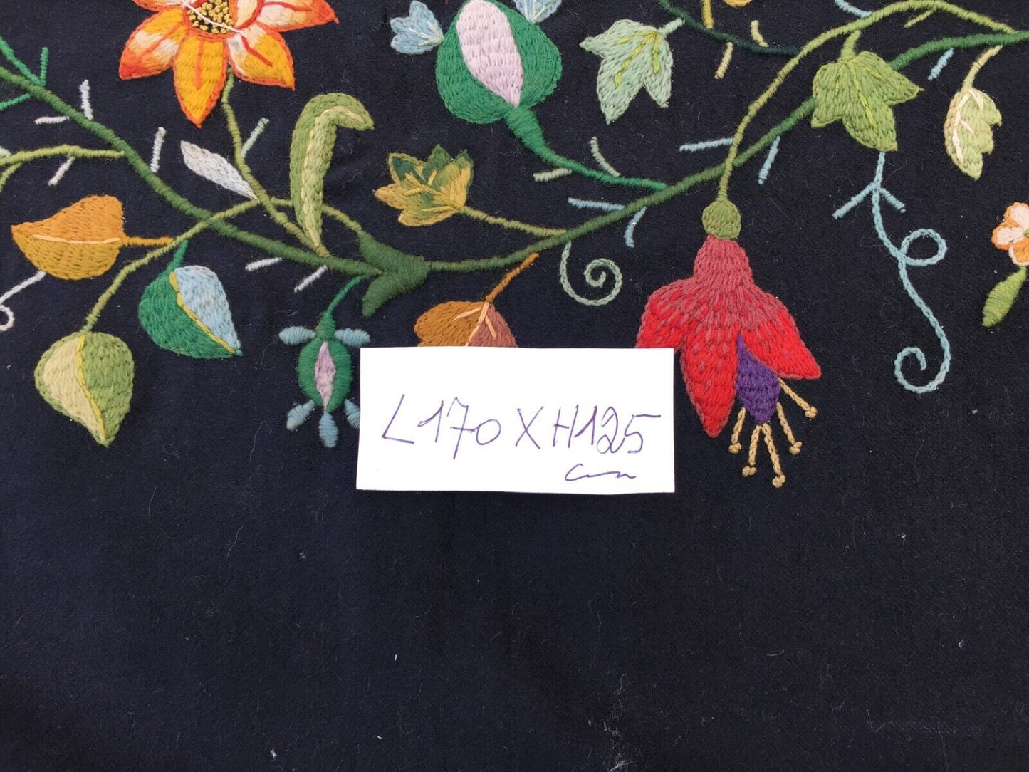 Side angle view of the rug, highlighting its high-quality wool material and vintage condition