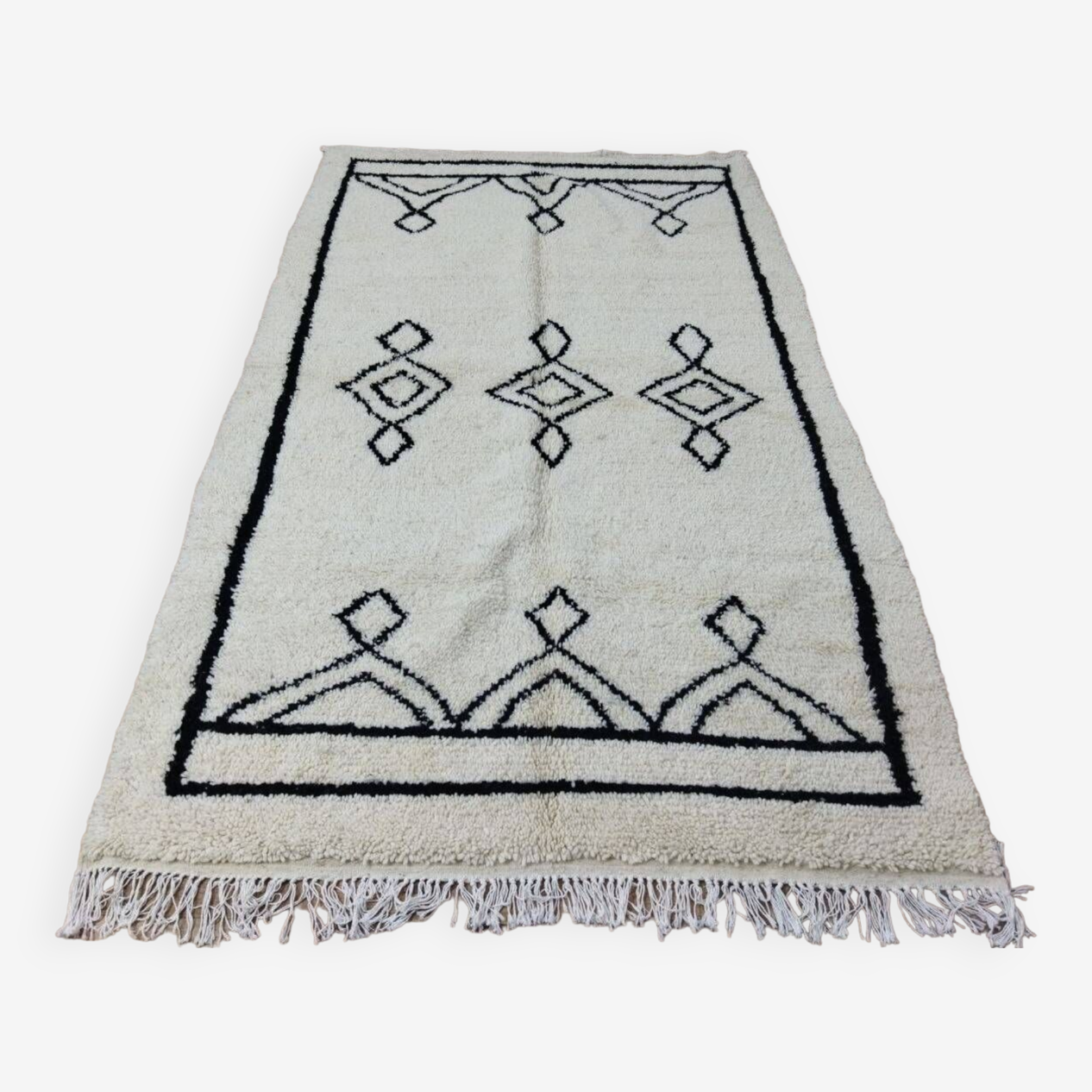 Vintage Moroccan Berber rug with black geometric pattern on light wool