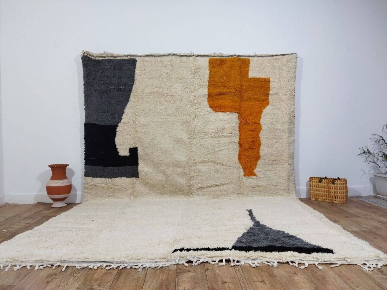 Large handwoven wool rug with soft pastels and tribal pattern