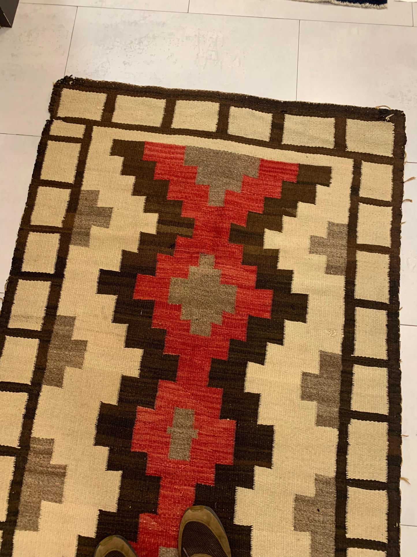 Detailed view of symmetrical motifs on the vintage Navajo rug