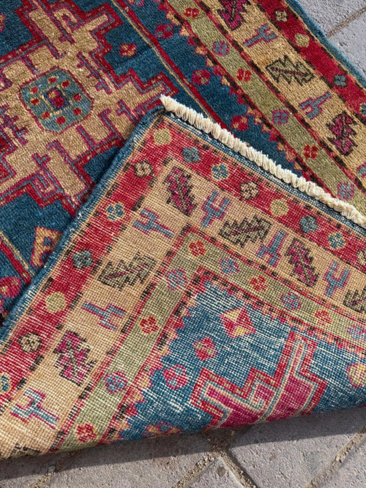 Series of fuchsia pink medallions on teal blue field