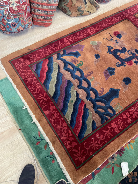 Close-up detail of the stylized dragon's head and swirling cloud forms.