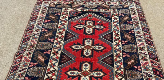 Close-up detail of a central medallion with intricate tribal motifs.