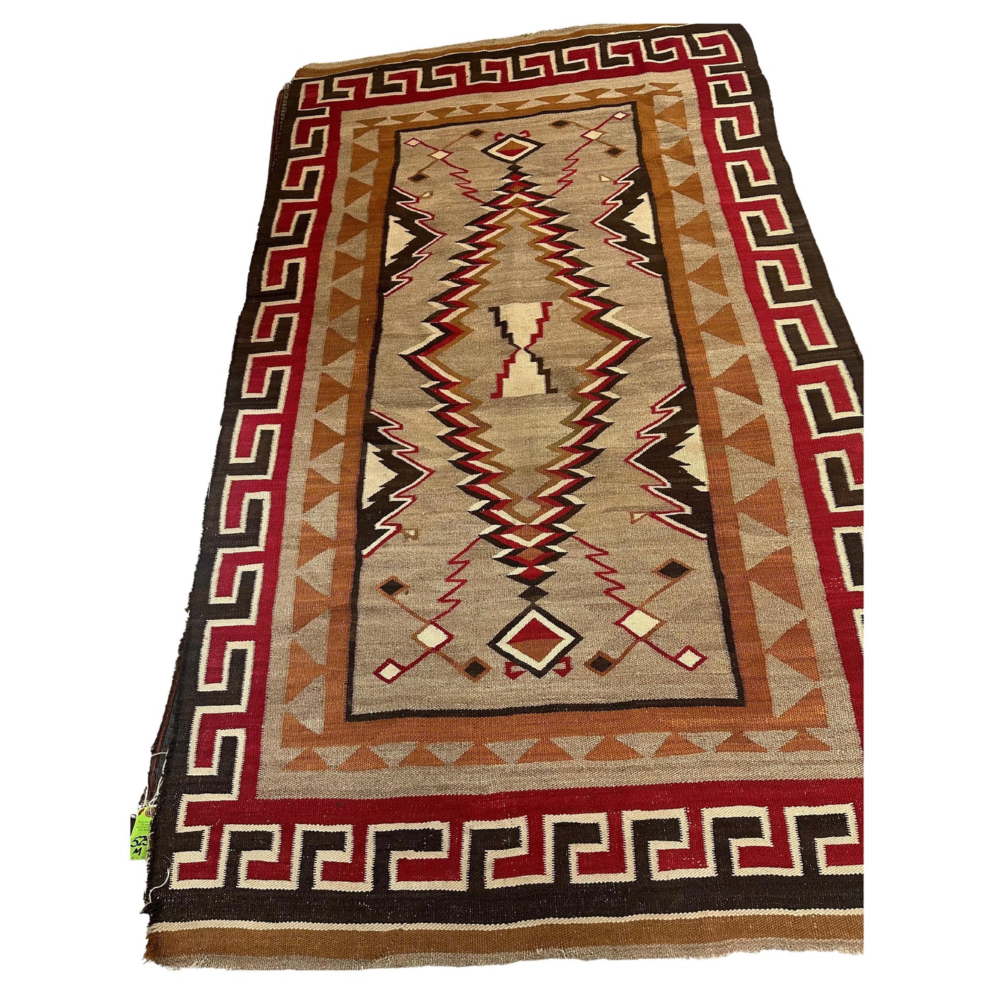 Rare antique Navajo wool rug featuring geometric patterns and earthy tones.