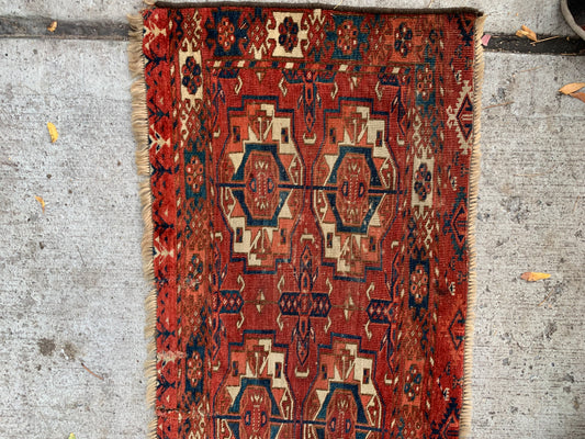 Close-up of octagonal medallions on a Tekke tribal rug.