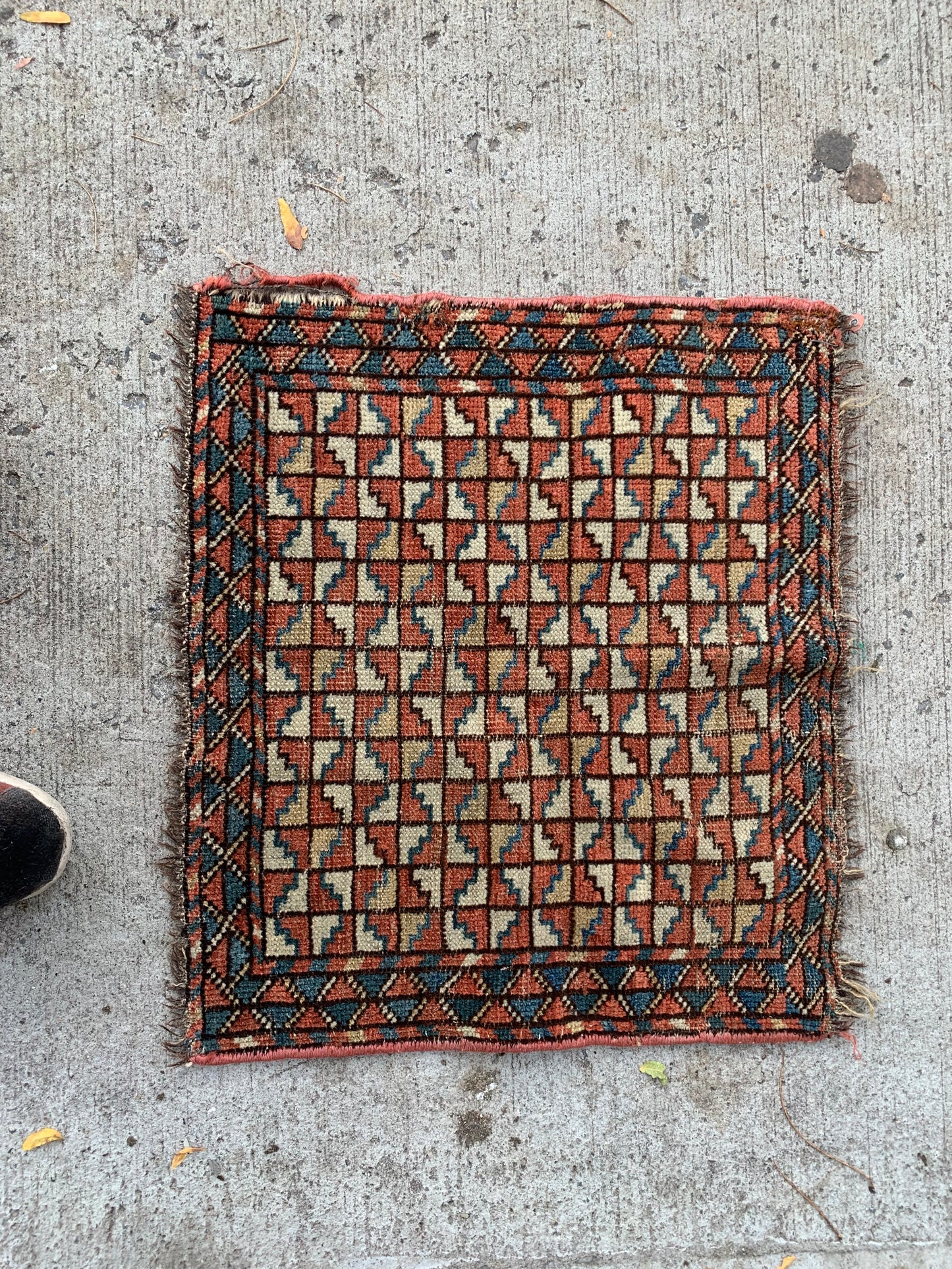 Antique Bashir bagface rug with rust red, ivory, and indigo tones.