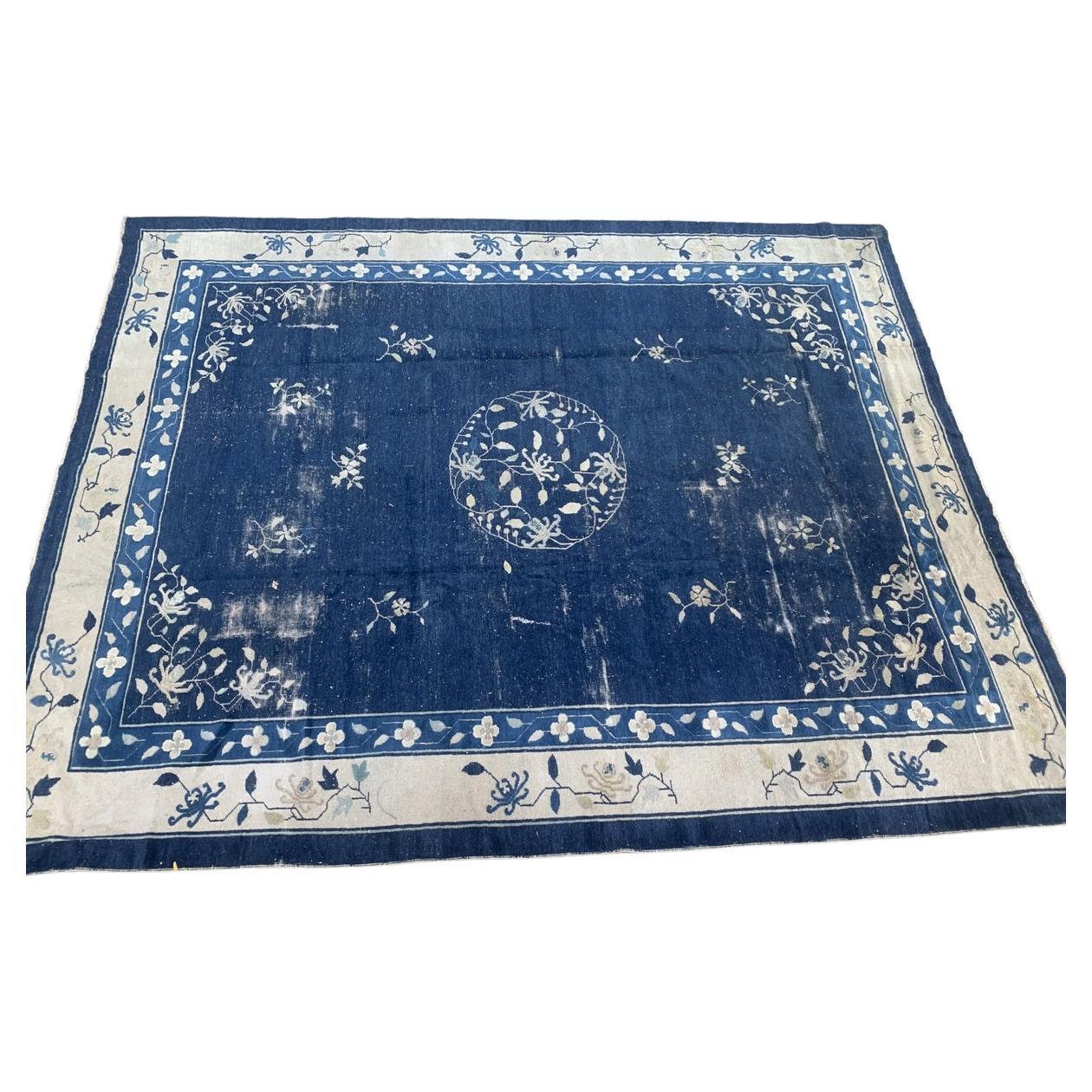 Antique Chinese Peking rug featuring floral motifs and a central medallion.