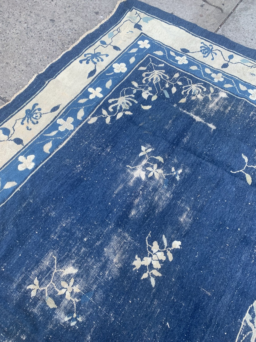 Rich navy blue and ivory tones in an antique Chinese rug.