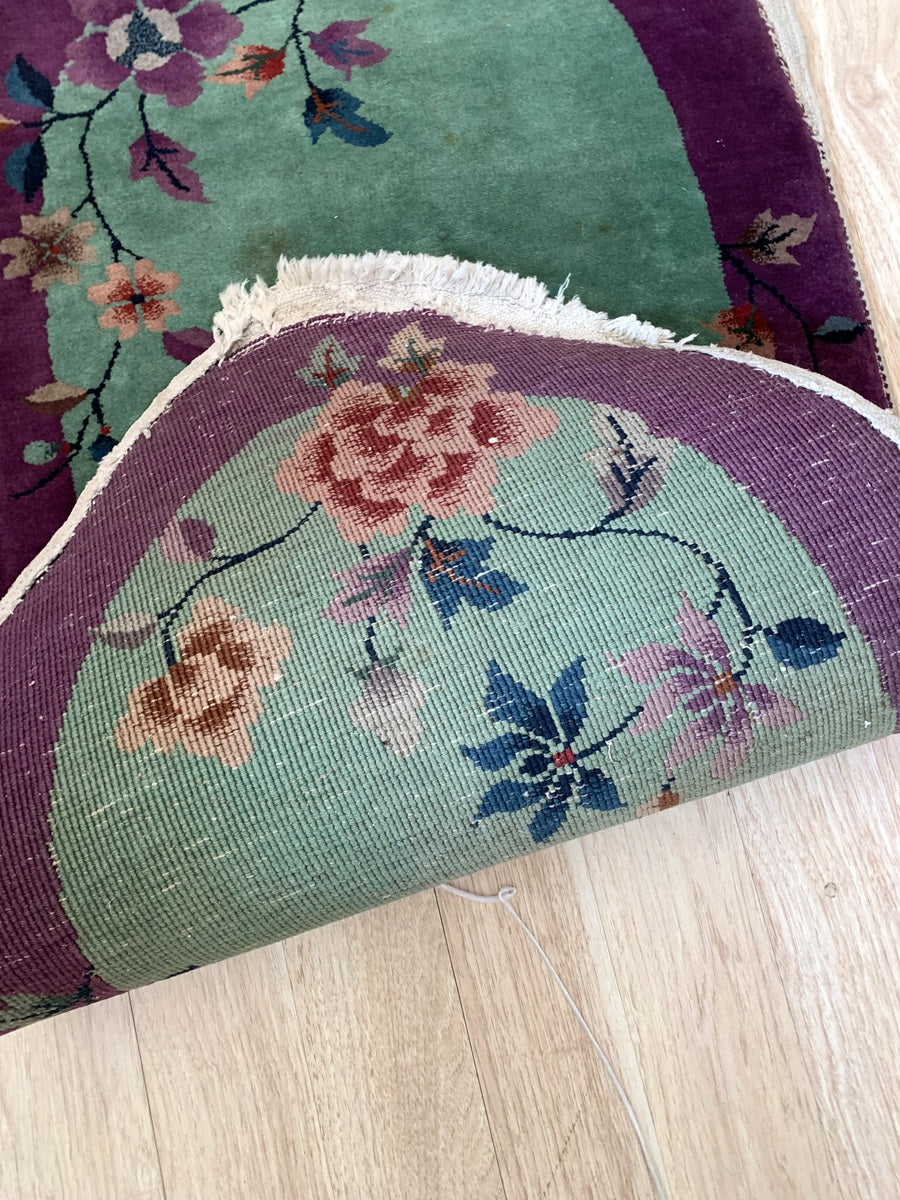 Petite handmade Art Deco rug with cascading floral vines.