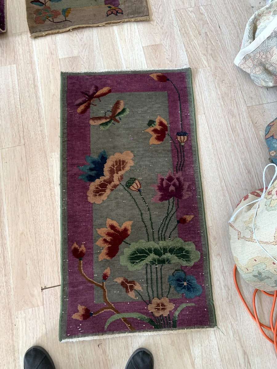 Detailed view of the rich plum, sage green, and burnt orange color palette.