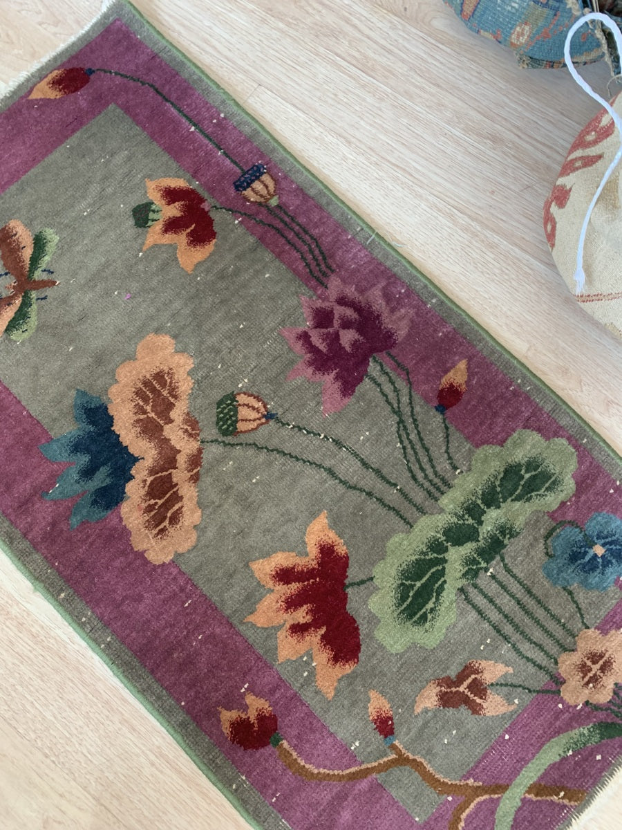 Muted greenish-grey background with intricate floral patterns.