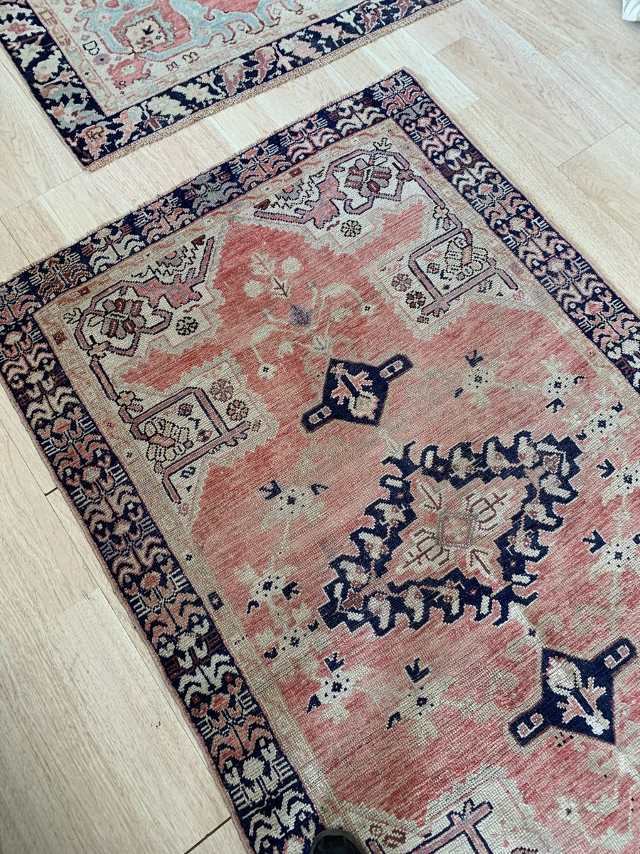 Hand-knotted wool texture with detailed vine patterns.