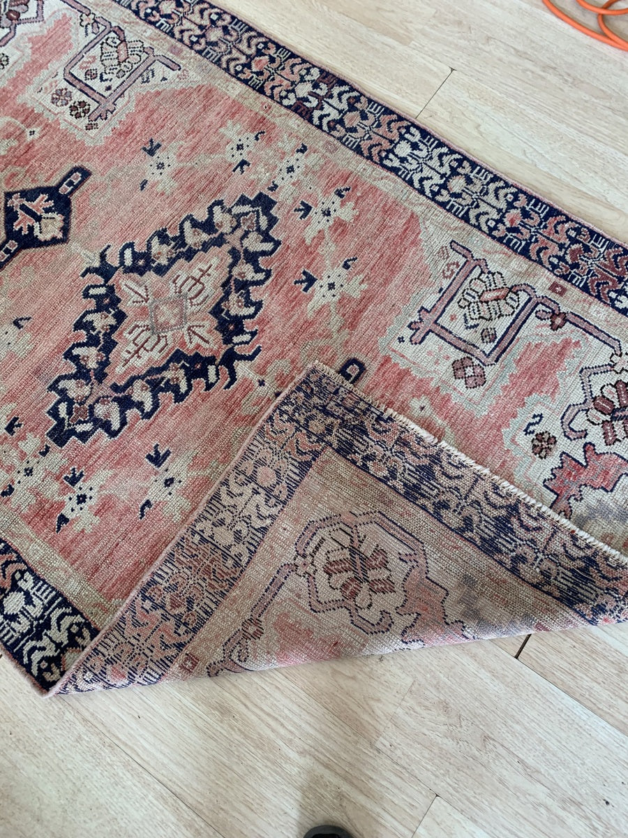 Dark navy-blue border with stylized floral embellishments.