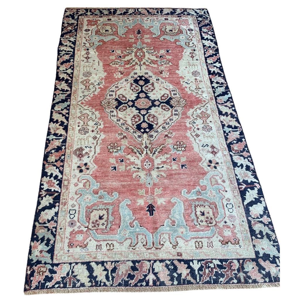 Handmade antique Turkish Anatolian rug with a medallion and floral motifs.