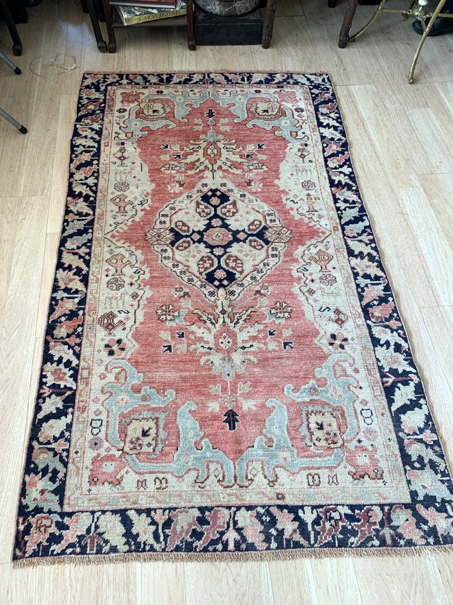 A beautifully aged 1920s Anatolian rug, showcasing its faded vintage charm.