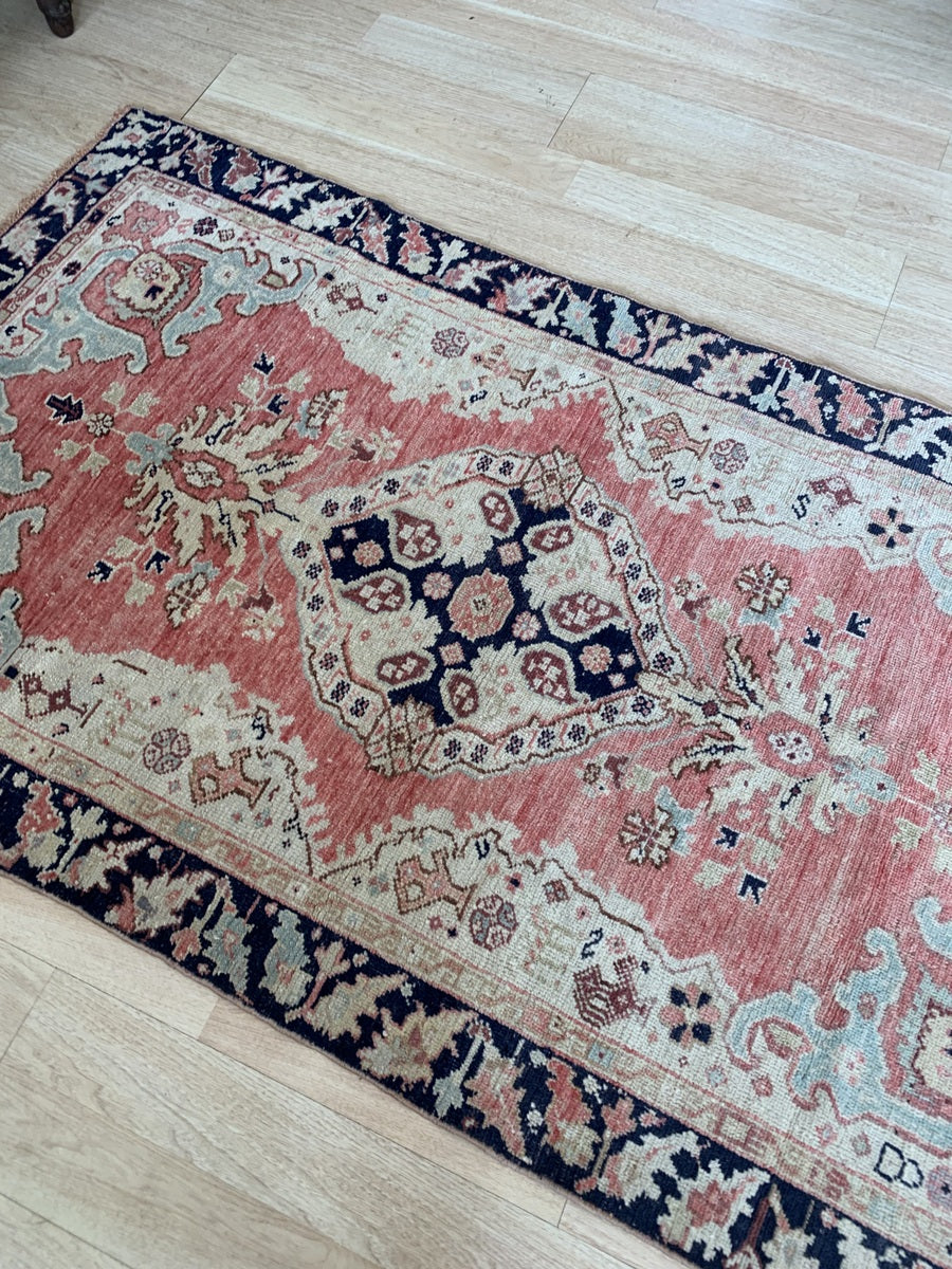 Vintage hand-knotted wool rug with a traditional Anatolian design.