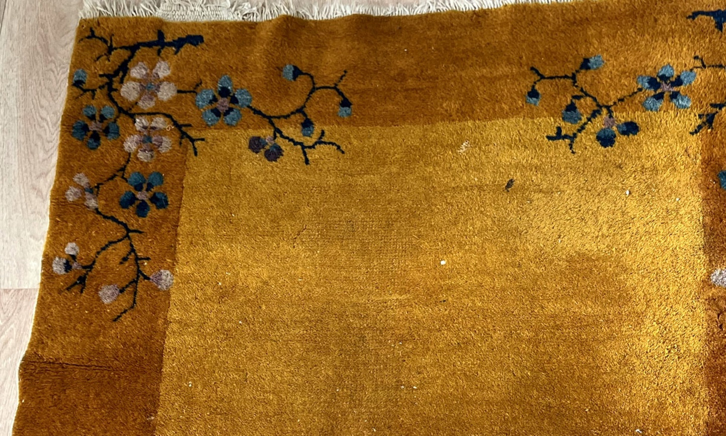 Rich golden-yellow field with a deep ochre border on the Art Deco rug