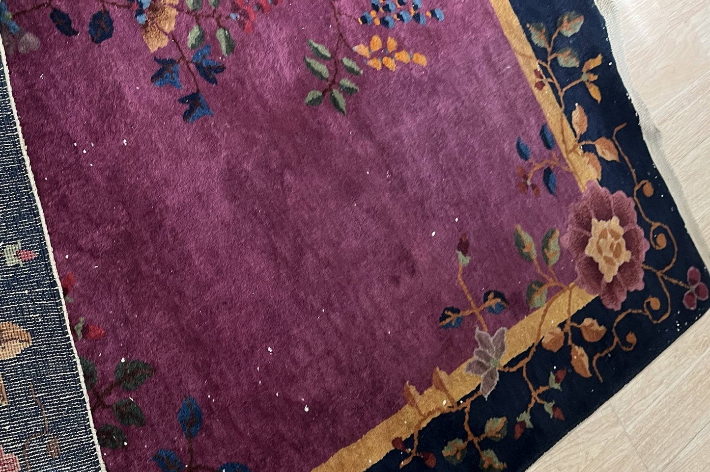 Worn areas of the rug, highlighting vintage authenticity