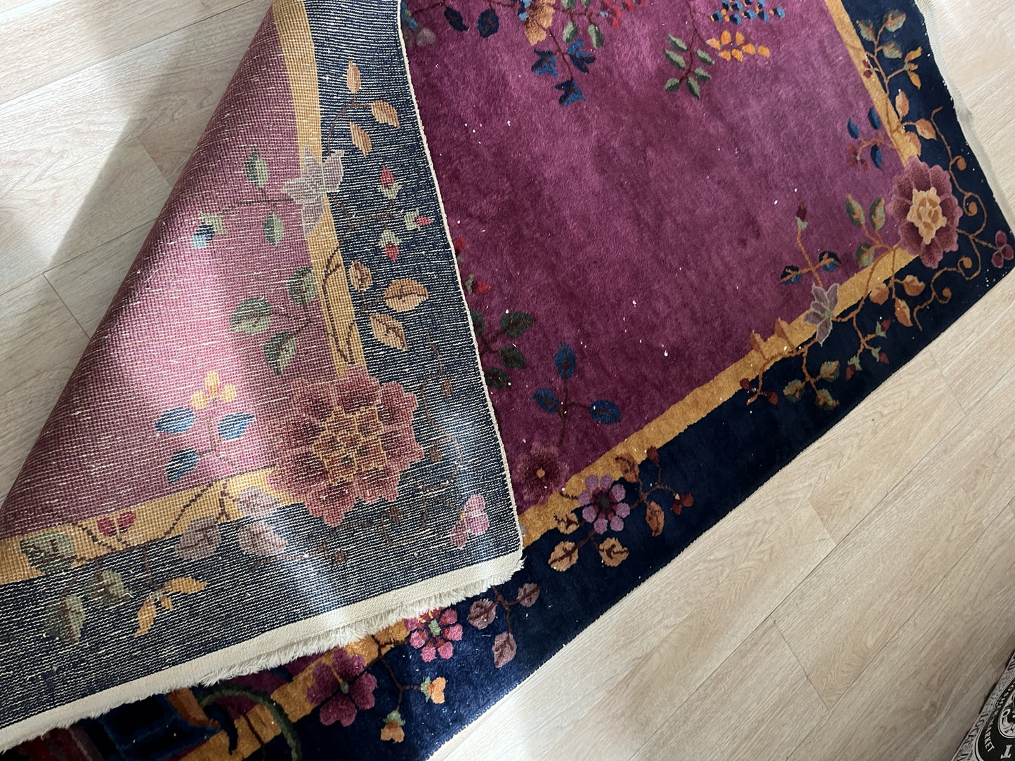 Side angle of the antique wool rug showcasing detailed patterns