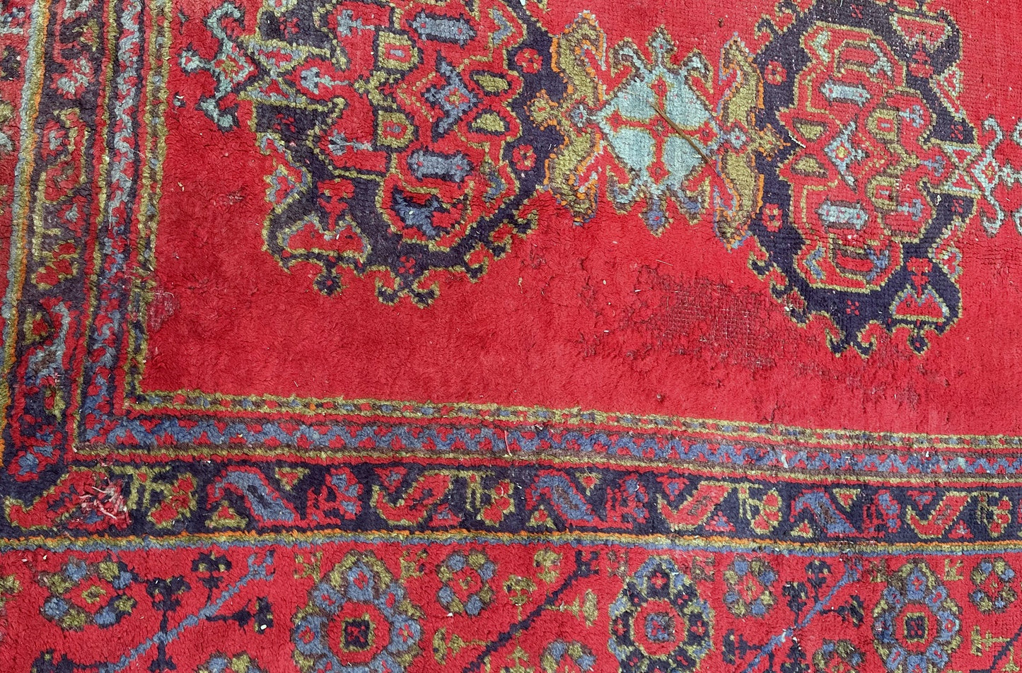 Antique Oushak rug displayed in a vintage-inspired room