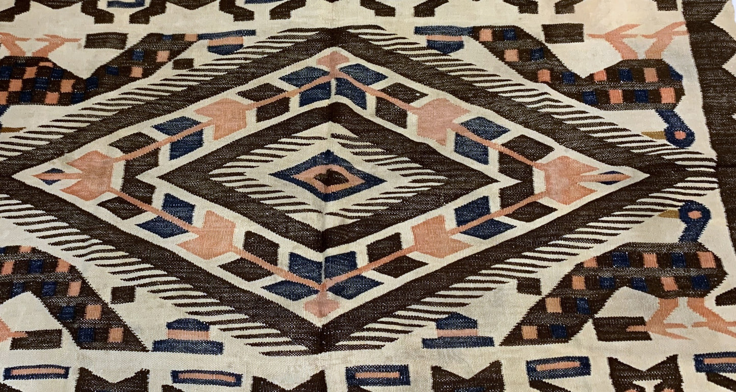 Earth-toned Peruvian textile with blue and peach accents