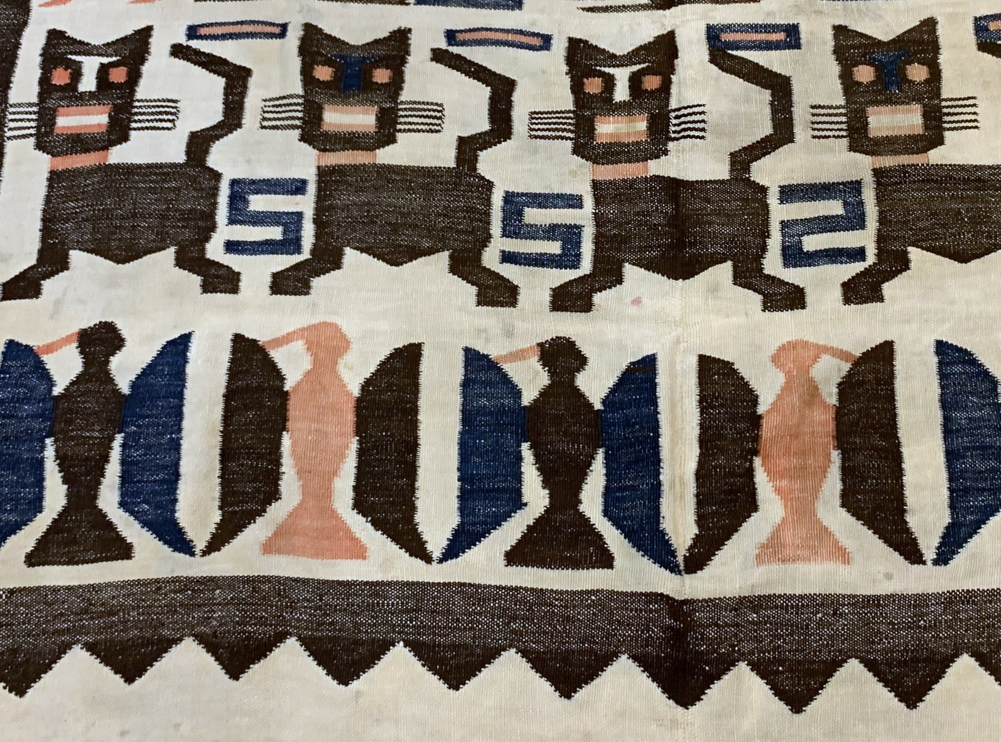 Traditional Peruvian rug with handwoven animal and human motifs