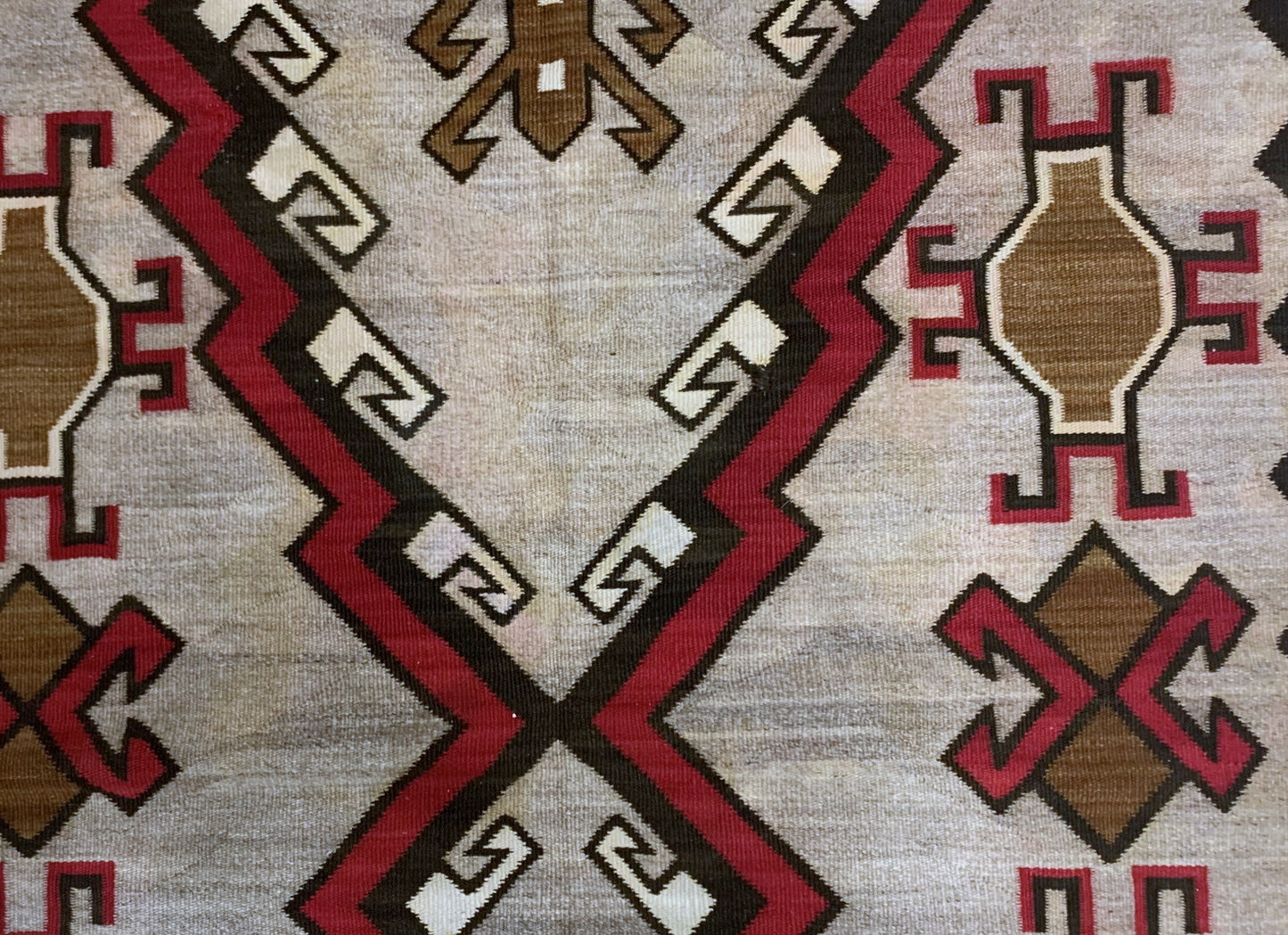 Deep red, brown, black, and white hues in a traditional Navajo rug
