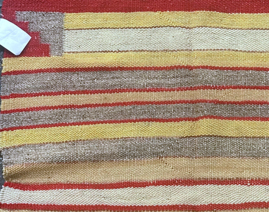 Close-up of warm-hued stripes and geometric corner designs