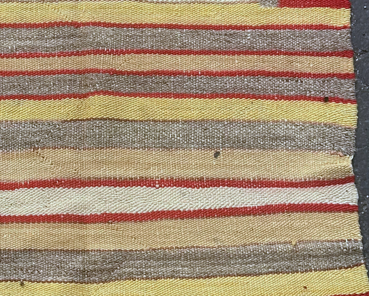Traditional red, yellow, beige, and brown striped Navajo textile