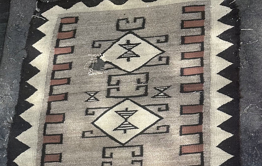 Close-up of intricate Navajo geometric patterns on wool rug