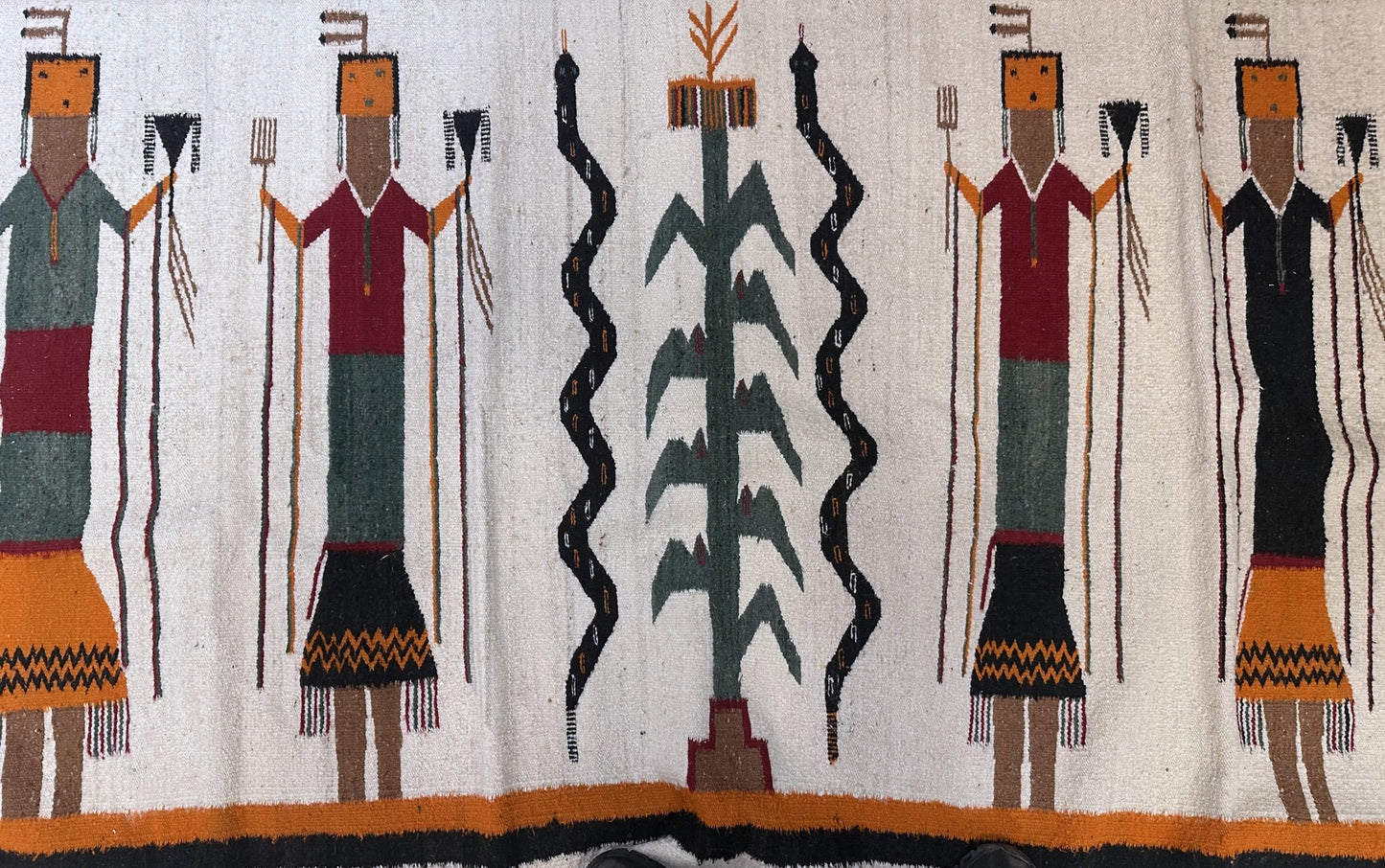 Textile with stylized figures and abstract designs on a white background