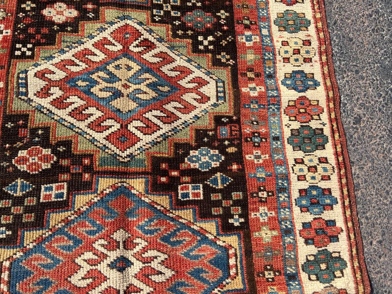 Border detail showing geometric repeats in ivory and red