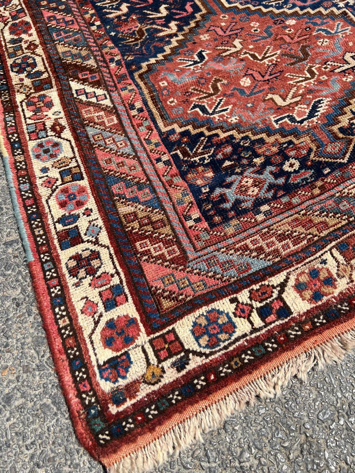 Interwoven motifs in rich terracotta and inky blue
