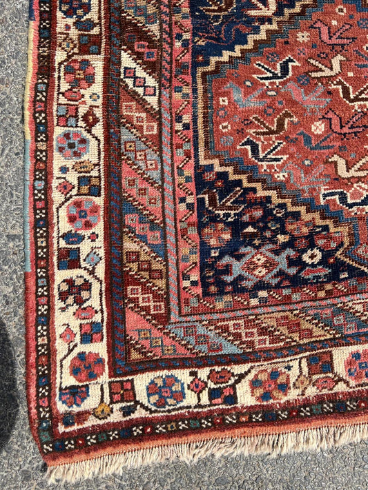 Close-up of hexagonal medallion with bird and animal motifs